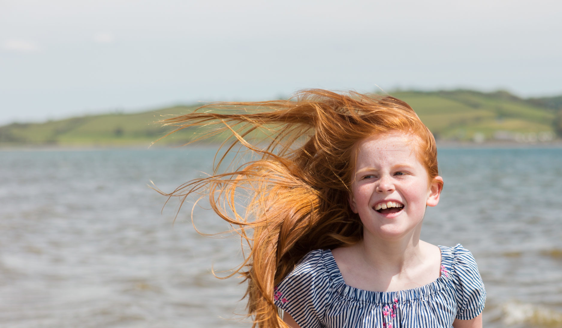 At the beach, a young girl has a great time